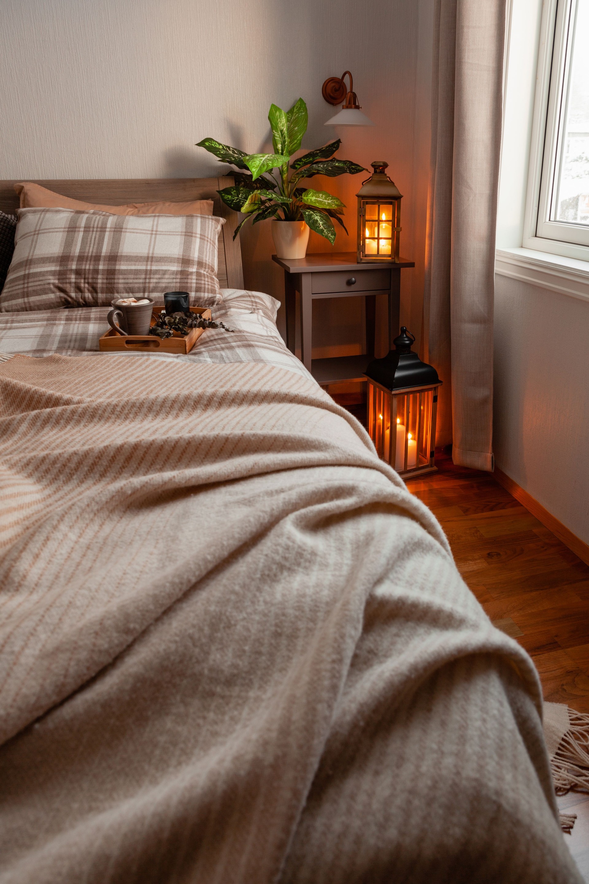 cozy scandinavian bedroom interior in natural tones, blanket candles houseplants